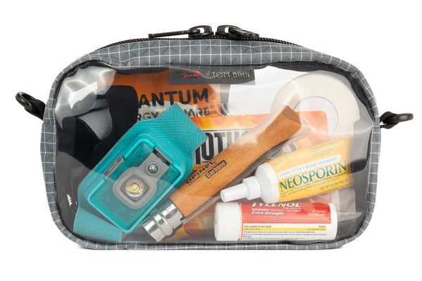 A Northwest Sky light grey with white grid pattern (Halcyon) 3D Clear Organizer Cube filled with sundries.